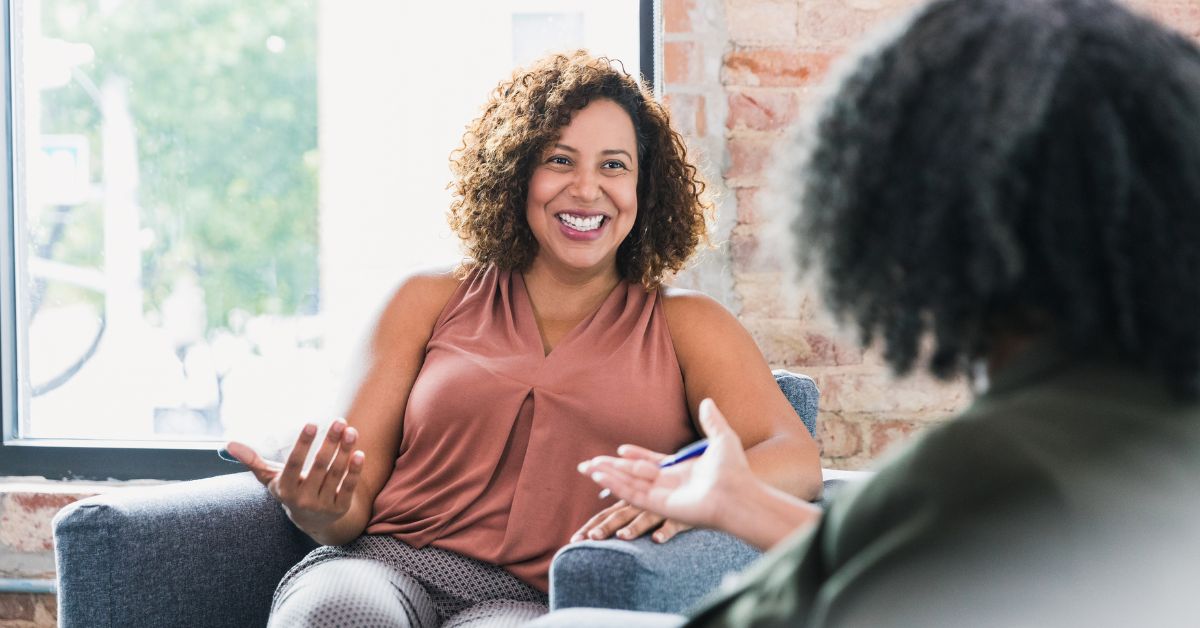 Client happily speaking to therapist