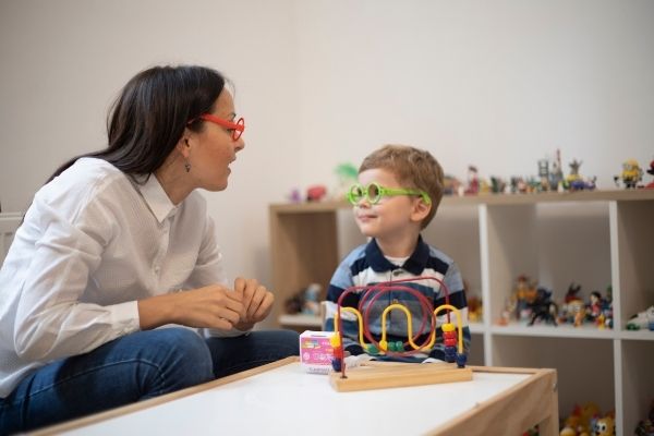 boy and woman smiling at each other with glasses on