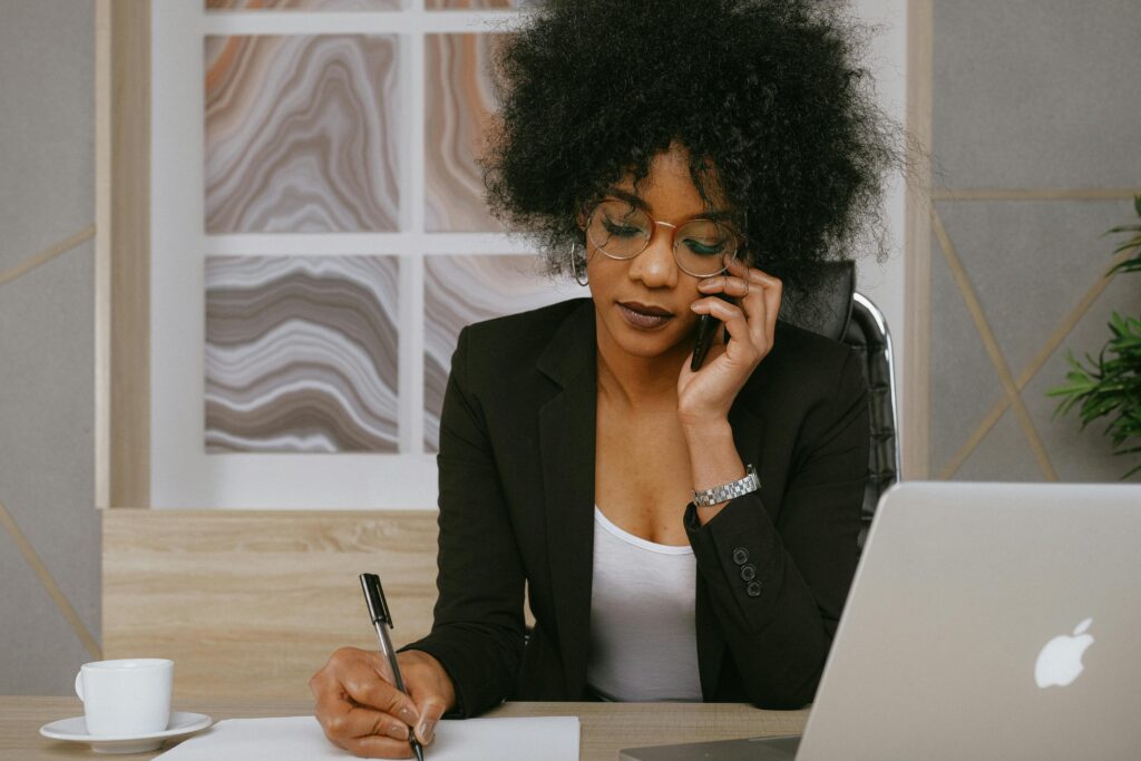 woman working at a desk and speaking on the phone